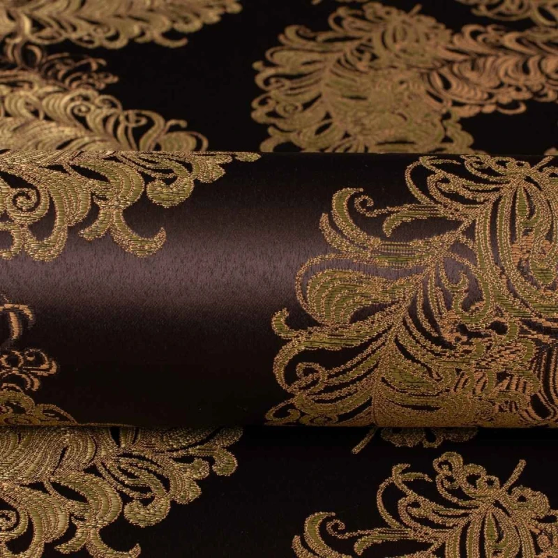 Ekskluzywny materiał obiciowy Diva z bogatym, błyszczącym złotym ornamentem na ciemnym tle