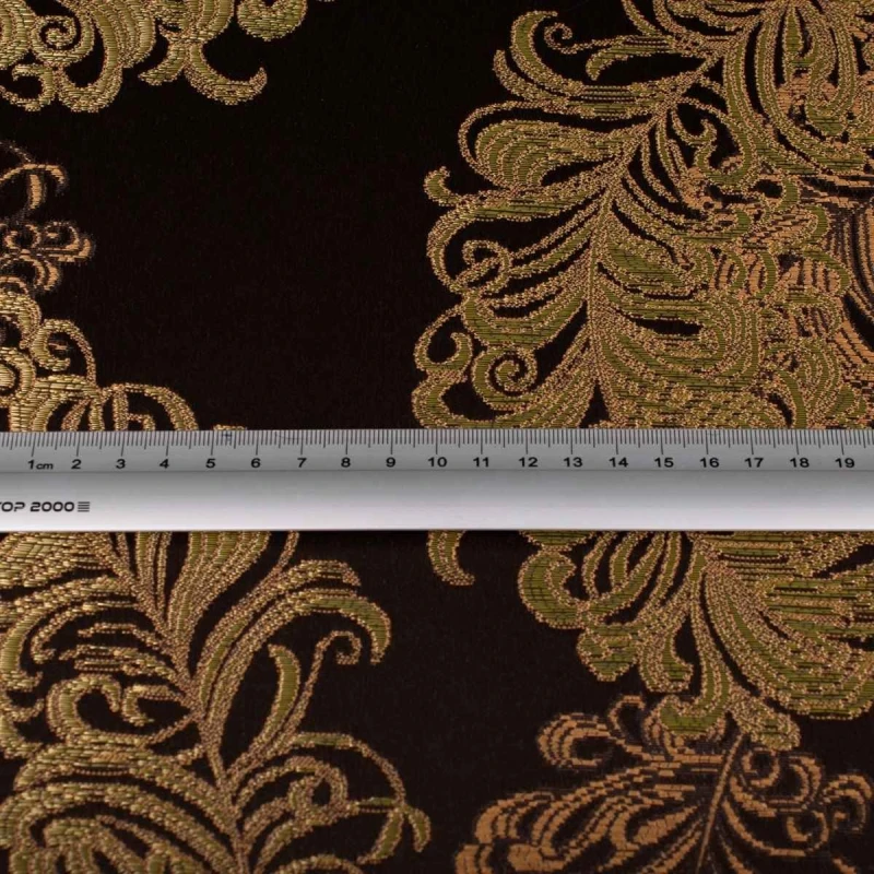 Ekskluzywny materiał obiciowy Diva z bogatym, błyszczącym złotym ornamentem na ciemnym tle zdjęcie z miarą